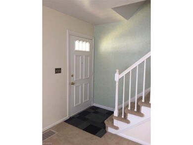 Foyer with slate floor and new front door.