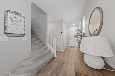 Entrance foyer featuring light wood-style floors and stairs