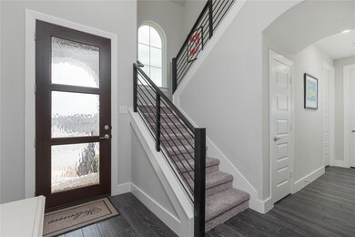 Entrance foyer with dark hardwood / wood-style flo