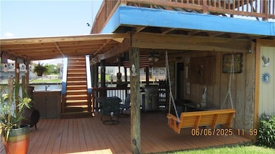 Covered area by water for BBQs, seafood boils, a TV for games, storage room with a toilet.