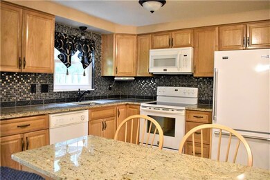 Kitchen:  New Oak Kitchen w/island, granite counter tops w/under mount stainless sink w/bronze faucet.  Mosaic-tile back splash.