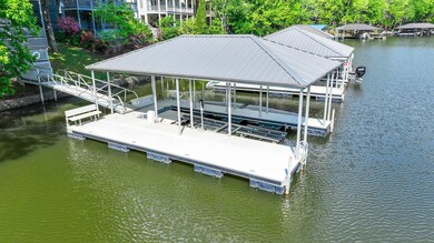 Dock area with boat lift and a water view