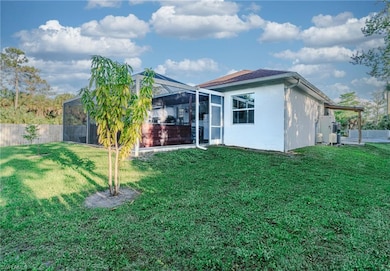 Rear view of property featuring fence, stucco sidi
