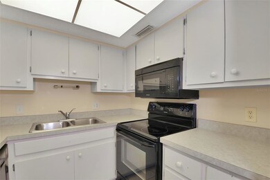 The kitchen boasts ample cabinetry for your culina