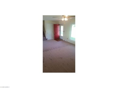 Spacious living room with hardwood entry flooring 