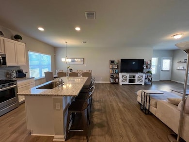 Kitchen featuring open floor plan, stainless stee