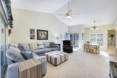Living room featuring high vaulted ceiling, light