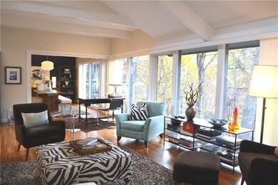 The entire back of the home has walls of glass, pe