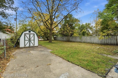 Fenced backyard with a storage shed