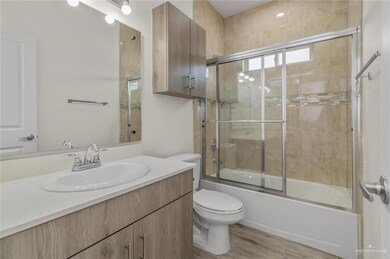 Bathroom featuring vanity, combined bath / shower with glass door, and wood finished floors