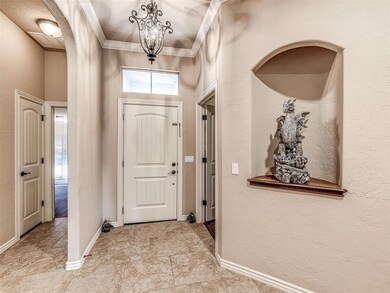 Foyer featuring baseboards, arched walkways, an in