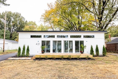 Back of property featuring a deck and a yard
