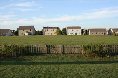 Wonderful green space is common area that provides privacy. Notice the gardens and fence gate. Pond is located to the right in the common area. 