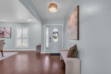 Foyer entrance with dark wood-style floors and baseboards