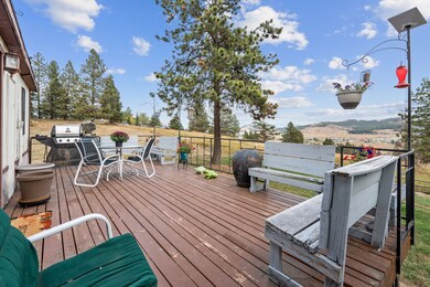 Wooden deck with area for grilling and a mountain view