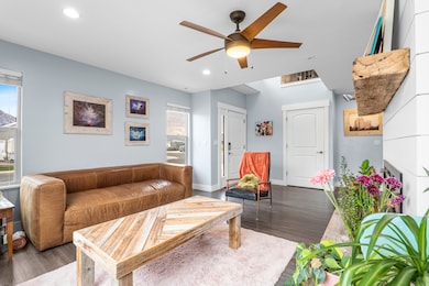 Living room featuring ceiling fan, wood finished floors, and recessed lighting