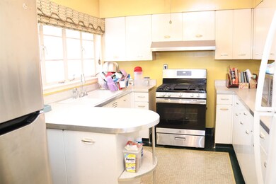 Kitchen with light countertops, appliances with st