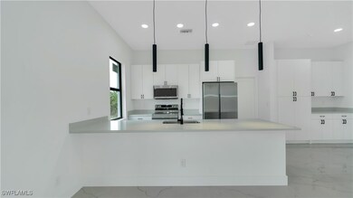 Kitchen featuring modern cabinets, light counterto
