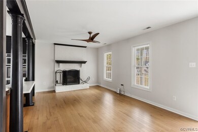 Unfurnished living room with brick wall, a firepla