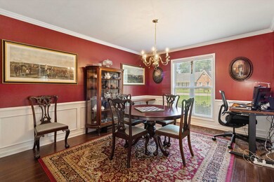 Dining space with crown molding, a chandelier, woo