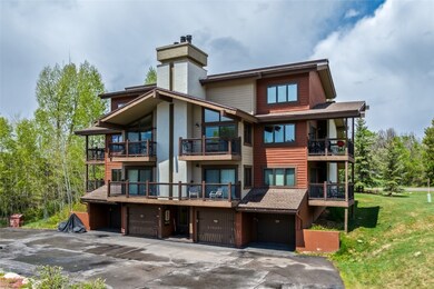Back of property with a balcony, a chimney, a yard