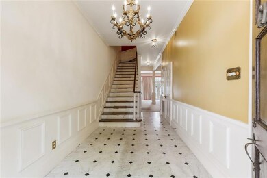 Classically elegant foyer mable flooring, chandeli