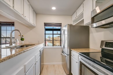 Kitchen featuring a sink, marble finish floor, ap