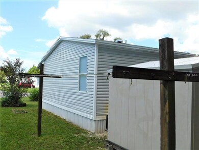 Side of home with outside clothes line.