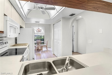 Kitchen featuring ceiling fan with notable chandel