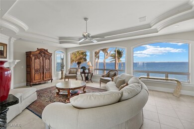 Living area with a raised ceiling, a water view, c