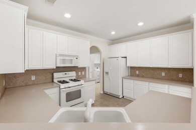 Counter height bar seating makes entertaining a breeze.  Convenient laundry and organization station just steps away.