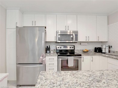 Kitchen featuring light stone counters, tasteful b