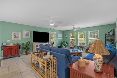 Living room featuring a ceiling fan and light tile patterned floors