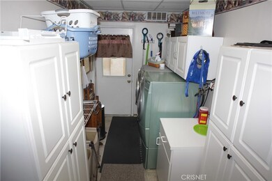 Separate laundry room with extra storage and additional outside access.