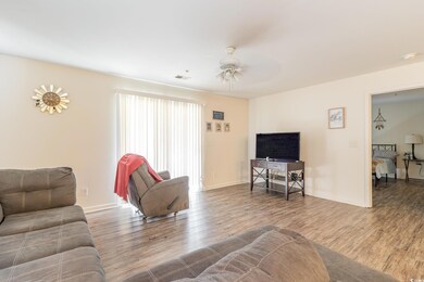 Living room with ceiling fan and wood-type flooring