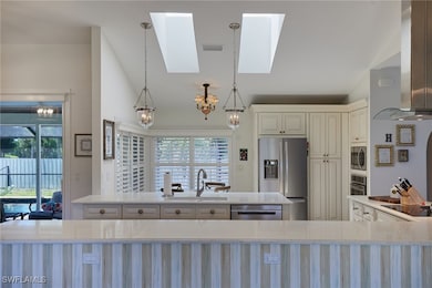 Kitchen featuring a sink, island exhaust hood, sta