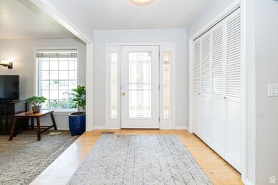 Entryway with hardwood flooring and baseboards