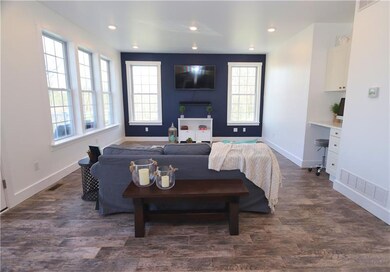 Natural light floods into the open living room wit