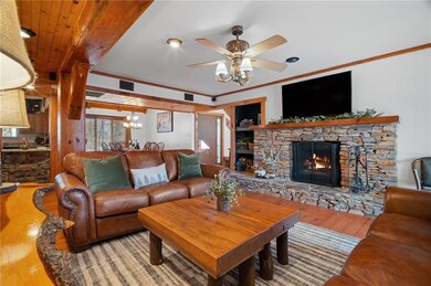 Great room featuring a stone fireplace, wood finis