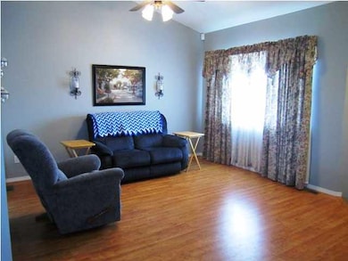 Large living room features wood laminate flooring,