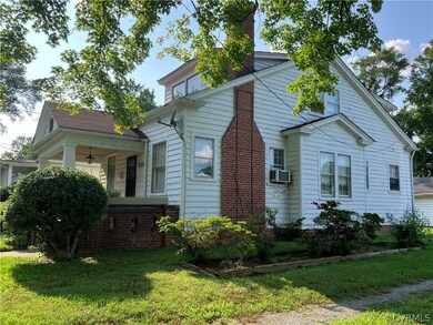 View of front of home featuring a front lawn and c