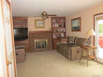 Open large family room with ceiling fan