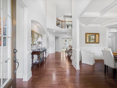 Step into the soaring two-story foyer filled with natural light.