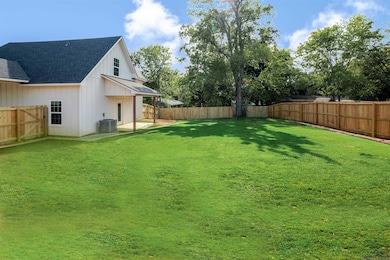 Fenced backyard with a patio area