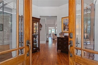 Entryway with french doors and dark wood finished floors