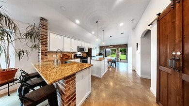 Kitchen with arched walkways, finished concrete f