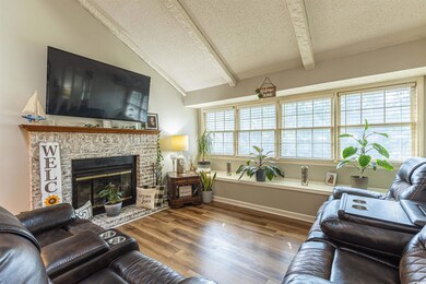 Living room featuring a brick fireplace, a texture
