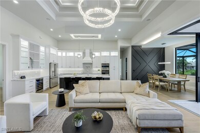 Living area featuring wine cooler, a chandelier, l