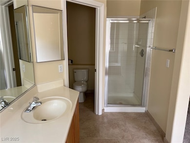 Bathroom with a stall shower, vanity, and light tile patterned floors