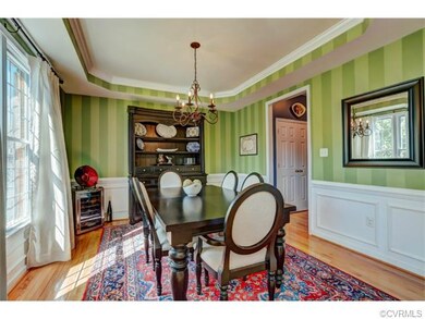 Stunning dining room with hardwood floors, crown m
